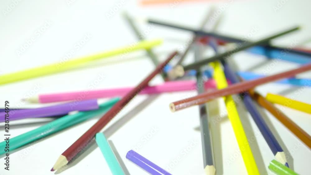 Pencil on a white background. Camera in motion. Colored pencils are in a chaotic manner Pencil on a white background. Camera in motion. Colored pencils are in a chaotic manner