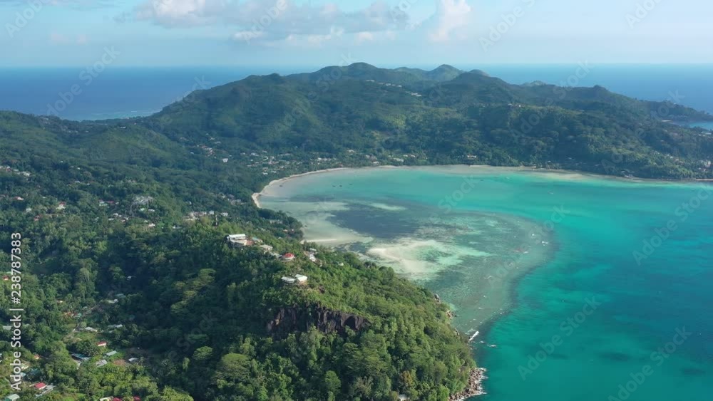 Aerial view of tropical paradise with white sand beach Anse A La Mouche, crystal clear waters of Indian Ocean, lush green tropical forest of Mahe Island - Seychelles Aerial view of tropical paradise with white sand beach Anse A La Mouche, crystal clear waters of Indian Ocean, lush green tropical forest of Mahe Island - Seychelles
