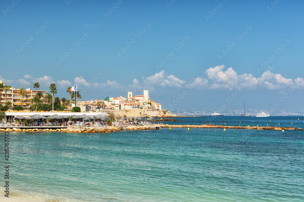 Beach restaurant in front of the old city wall of the French town of Antibes