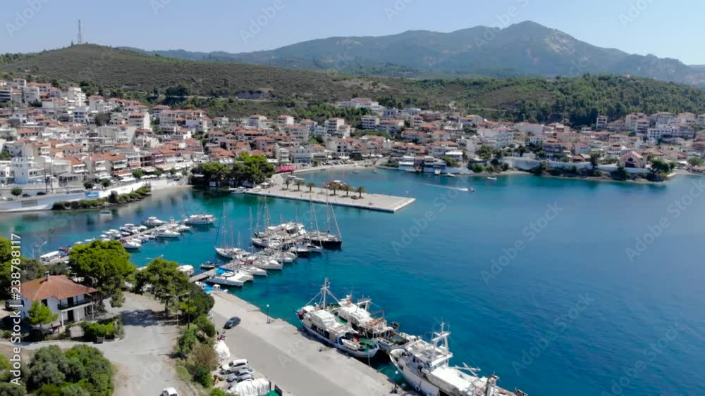Drone aerial view over blue sea water on coast of Neos Marmaras town on the Sithonia , Chalkidiki , Greece Drone aerial view over blue sea water on coast of Neos Marmaras town on the Sithonia , Chalkidiki , Greece