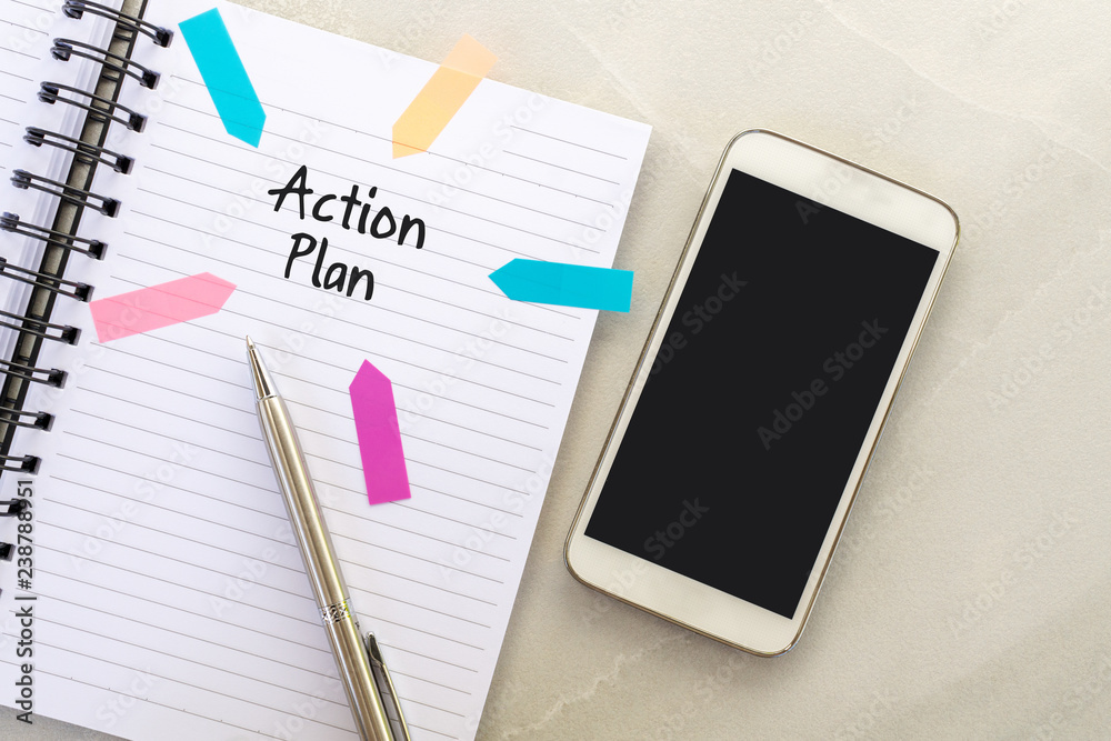 Action plan text on note pad with smart phone and pen. Action plan text on note pad with smart phone and pen.