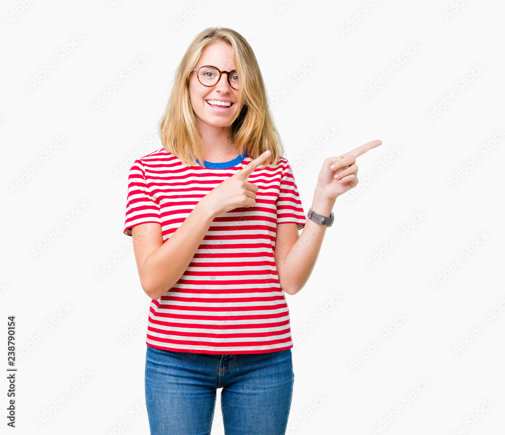 Beautiful young woman wearing glasses over isolated background smiling and looking at the camera pointing with two hands and fingers to the side. Beautiful young woman wearing glasses over isolated background smiling and looking at the camera pointing with two hands and fingers to the side.