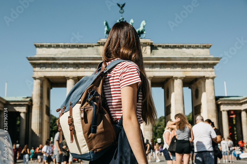 Canvas Print A tourist or a student with a backpack in Berlin in Germany visits the sights