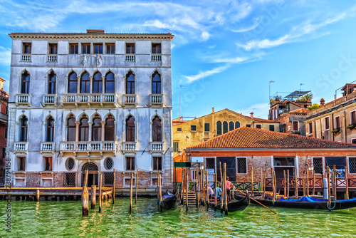 Gondoliers near gondolas rent station by Garzoni Palace in Venic photo