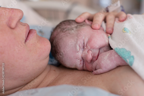 A new mom and her baby are bonding in the hospital after a long birth.