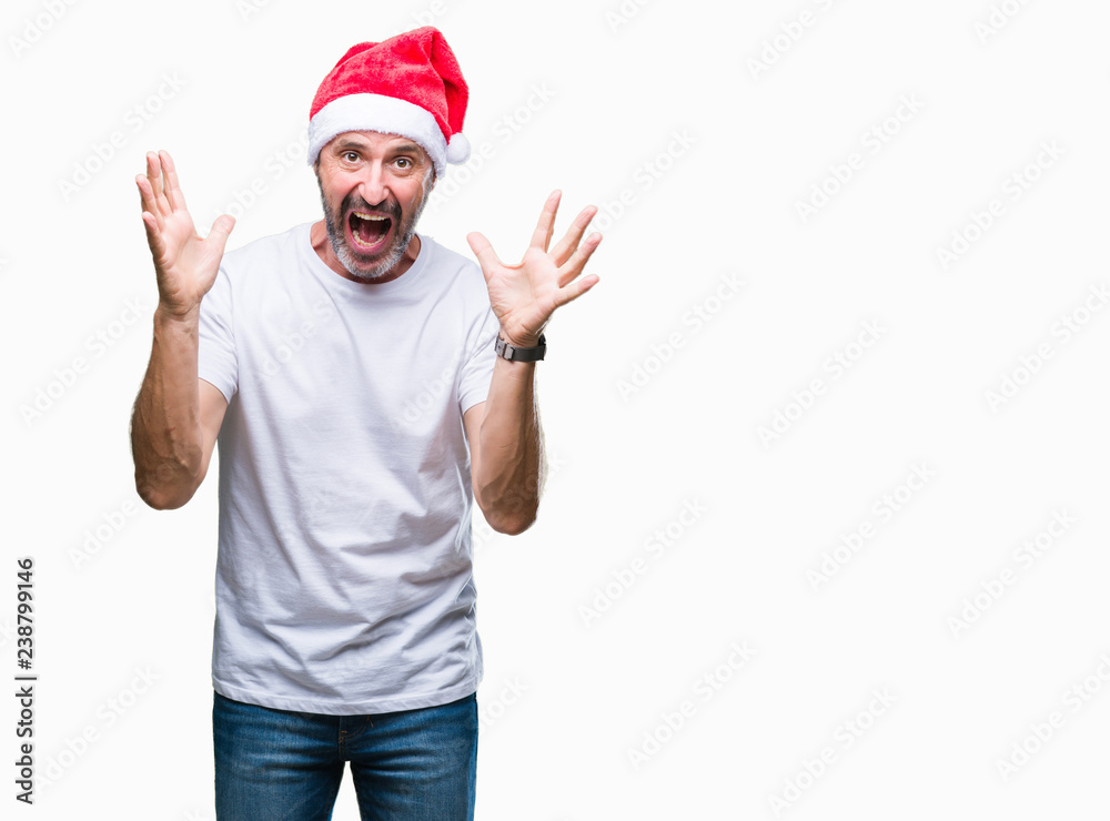 Middle age hoary senior man wearing christmas hat over isolated background celebrating crazy and amazed for success with arms raised and open eyes screaming excited. Winner concept Middle age hoary senior man wearing christmas hat over isolated background celebrating crazy and amazed for success with arms raised and open eyes screaming excited. Winner concept