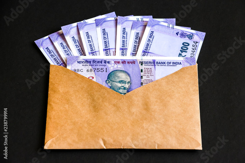 Close up view of envelope with brand new indian one hundred rupees banknotes.
