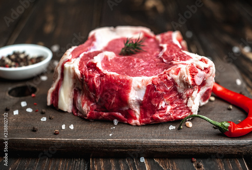 fresh raw beef steak on wooden cutting board