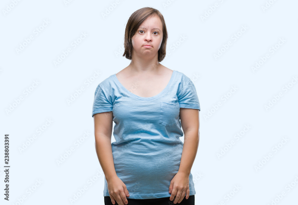 Young adult woman with down syndrome over isolated background with serious expression on face. Simple and natural looking at the camera. Young adult woman with down syndrome over isolated background with serious expression on face. Simple and natural looking at the camera.