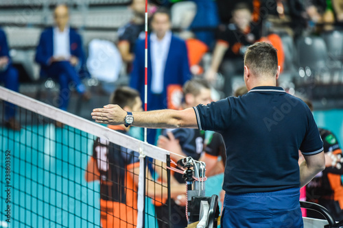 Volleyball referee gives sign who score the point photo