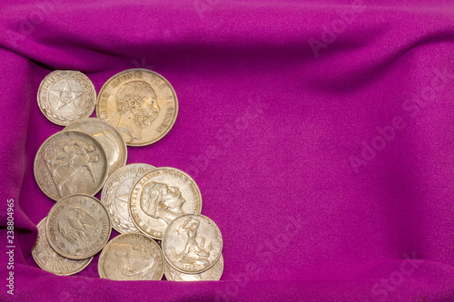 Slika na platnu Twentieth-century silver coins on a purple velvet napkin in a casket, close-up, collectible coins, Soviet rubles, German marks, Russian and German empires