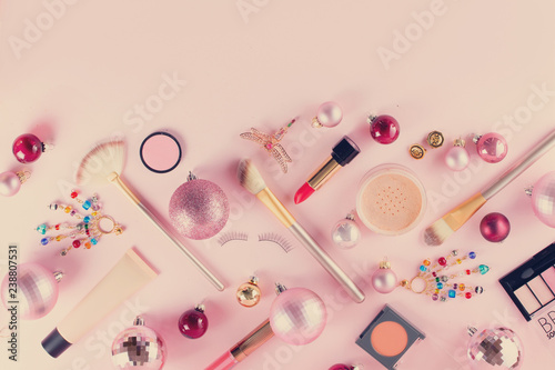 Festive make up products border on pink background, retro toned