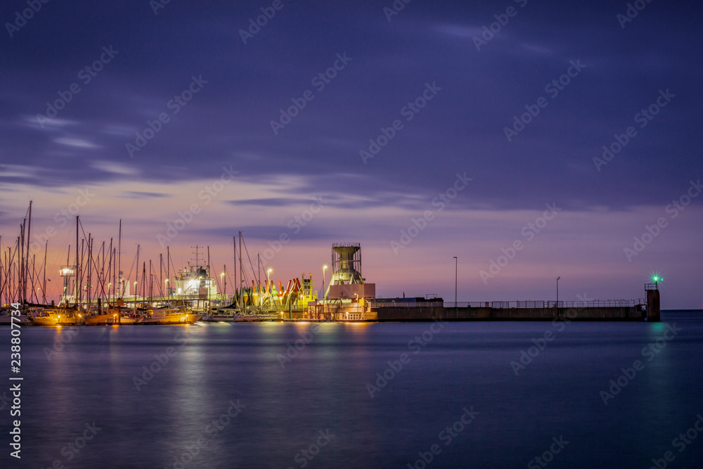 Fototapeta premium Yacht port of Cuxhaven Germany with night lights on at sunset.