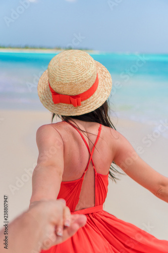 Young girl in beautiful red dress background the sea