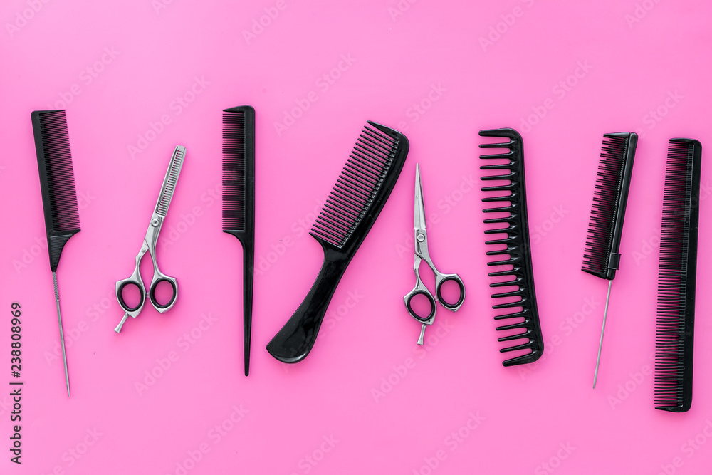 Set of professional hairdresser tools with combs pink background top view Set of professional hairdresser tools with combs pink background top view