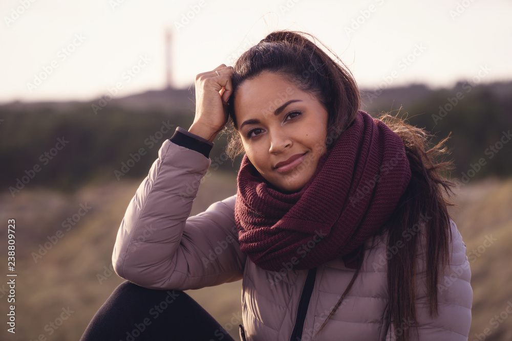 Portrait of exotic young female with winter clothes on.