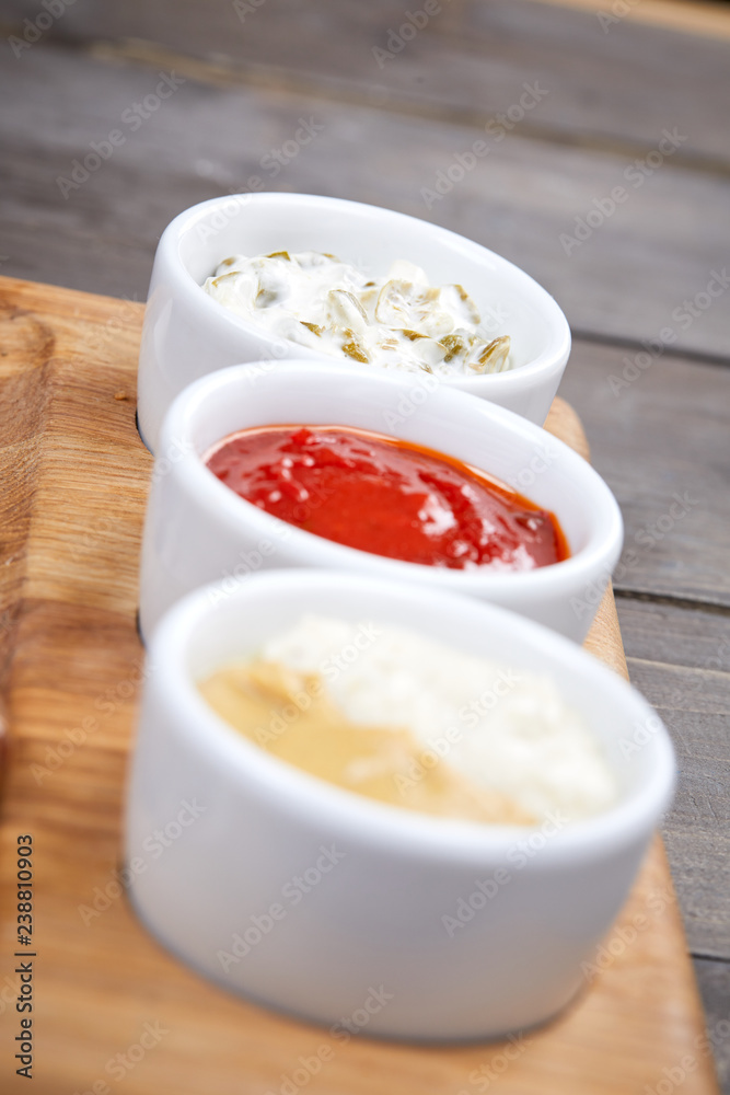 different sauces on the wooden background different sauces on the wooden background