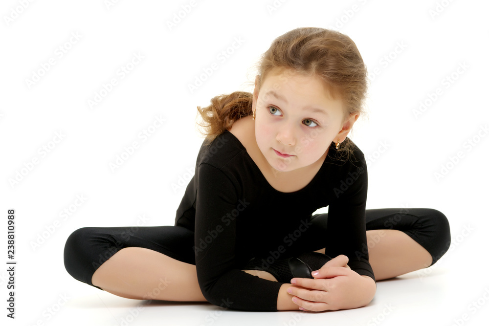 The little gymnast perform an acrobatic element on the floor. The little gymnast perform an acrobatic element on the floor.