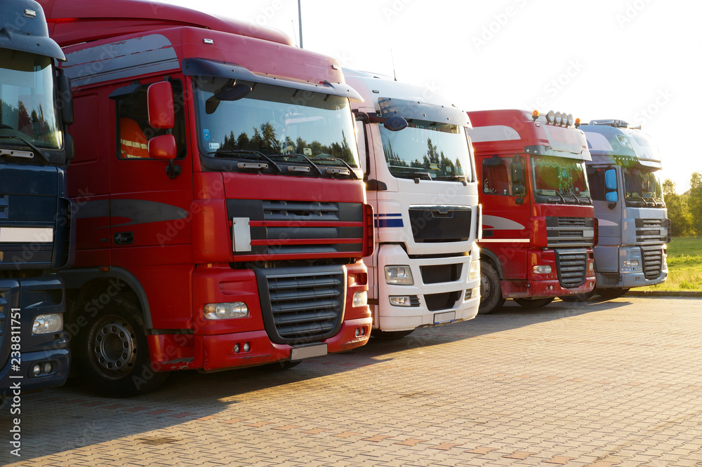 Transportation. Several trucks lined up in a row on a parking lot. Transportation. Several trucks lined up in a row on a parking lot.