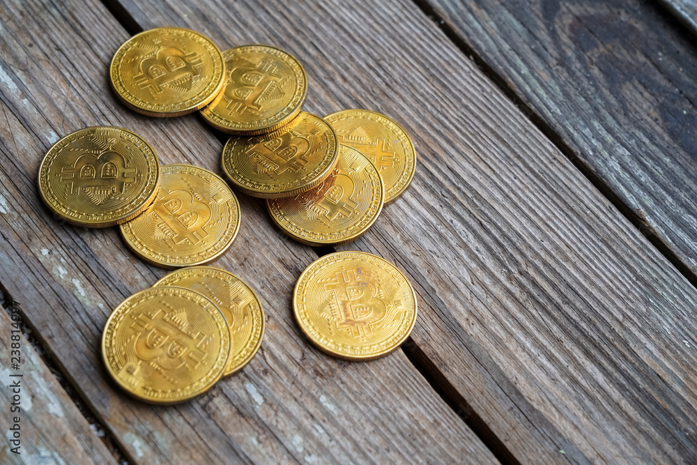 Gold Bitcoin money on wooden table. Electronic crypto currency Gold Bitcoin money on wooden table. Electronic crypto currency