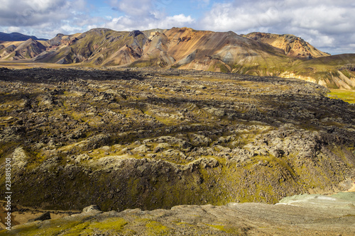 Panoramic view over the lava field of Laugahraun and the colorful mountains of Landmannalaugar, Iceland, seen from the volcano of Blahnukur.