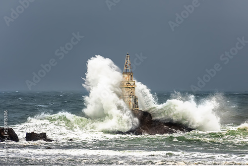 Storm wave at sea lighthouse. Ahtopol, Bulgaria