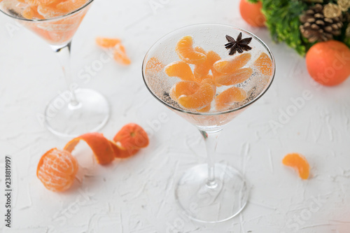 winter alcohol coctkail with fresh tangerine and vodka on white background photo