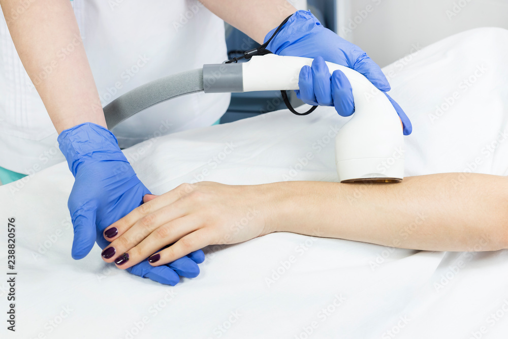 The process of laser depilation of female limbs in the beauty salon. The process of laser depilation of female limbs in the beauty salon.