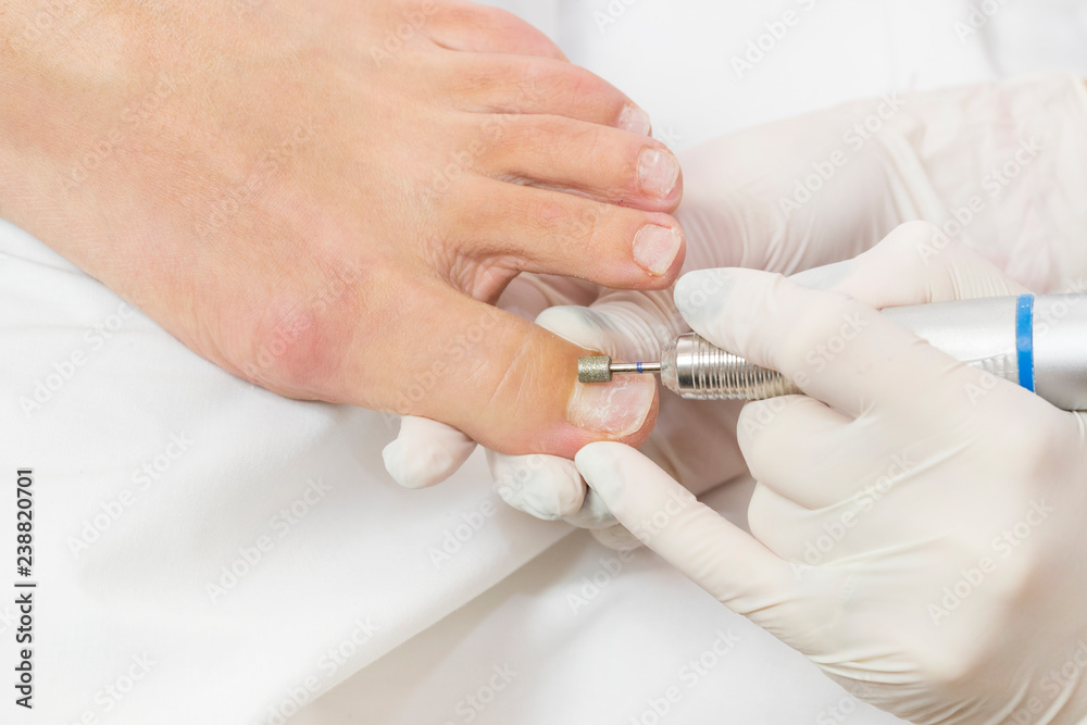 Process of pedicure at beauty salon close up 