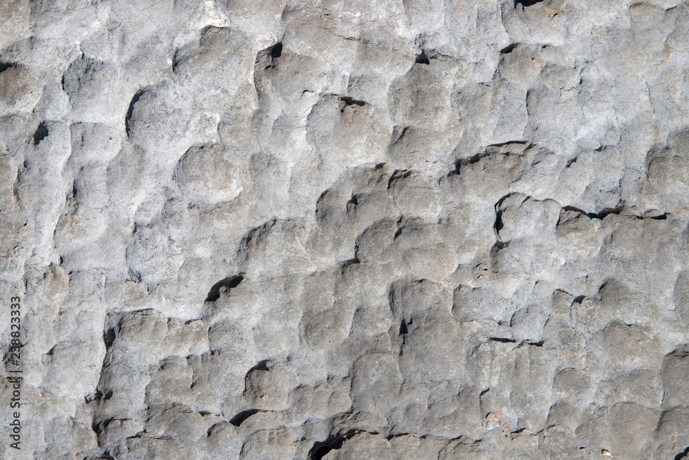Pale rock rough texture. Stone surface photo. Chipped stone surface with cutter marks. Aged stone wall closeup. Pale rock rough texture. Stone surface photo. Chipped stone surface with cutter marks. Aged stone wall closeup.