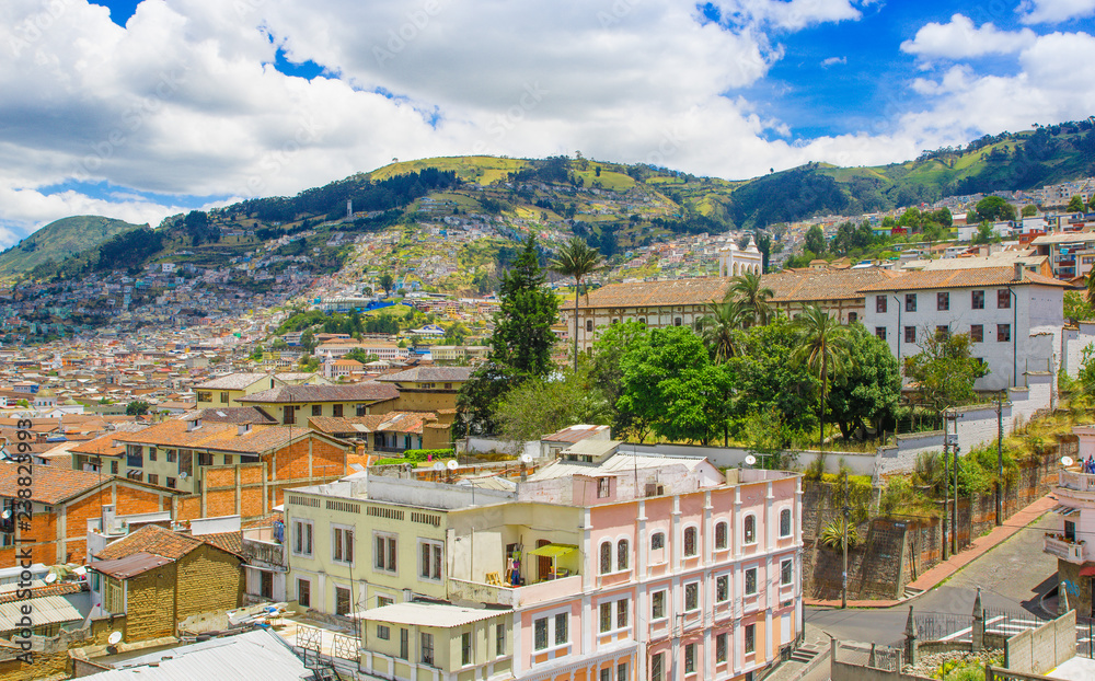 Top view of rooftops of the colonial town with some colonial houses located in the city of Quito