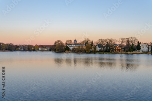 Scenery of Heiliger see, the lake in Potsdam, Germany and waterside in winter during sunset twilight time and sky. © Peeradontax