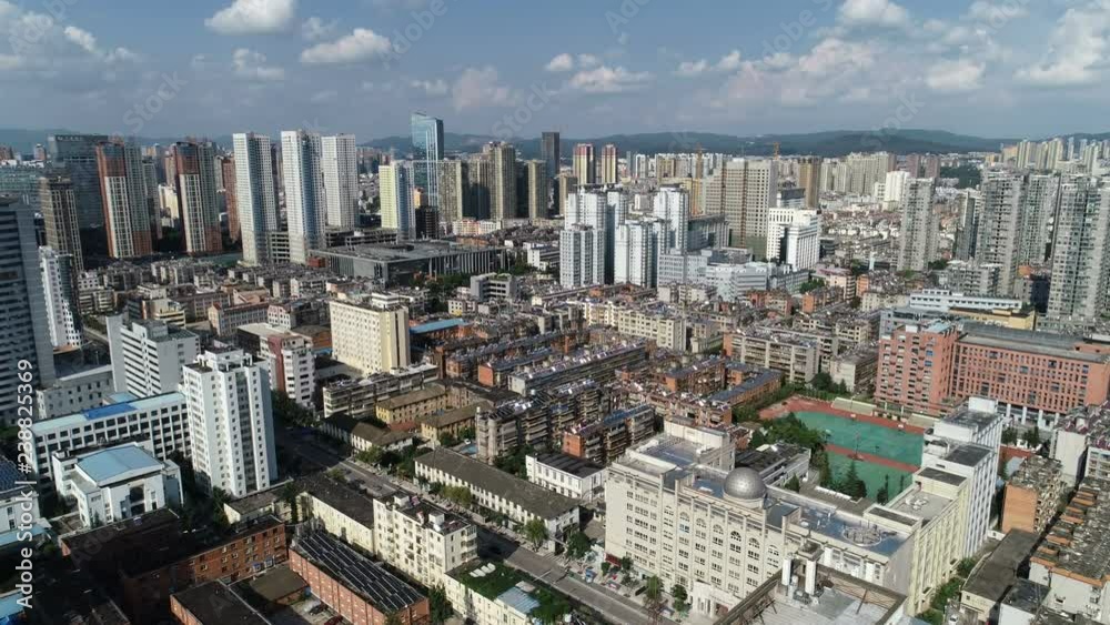 Establishing drone shot of high-rise apartment buildings and office towers in Kunming, urban development in China Establishing drone shot of high-rise apartment buildings and office towers in Kunming, urban development in China