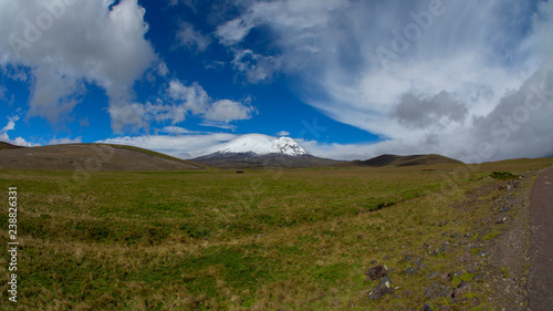 Panoramic view of Antisana volcano in a day with cloudy blue sky. Antisana is a stratovolcano of the northern of Ecuadorian Andes