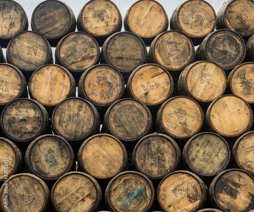 Stacked pile of old wooden barrels and casks at Speyside Cooperage in Scotland