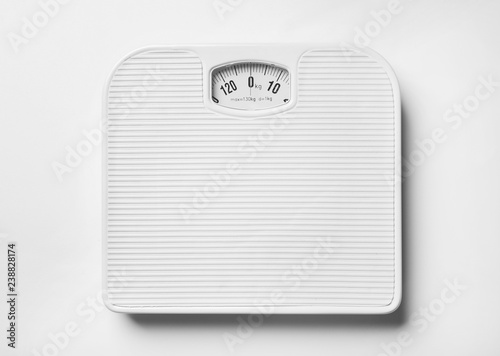 Bathroom scales on white background, top view. Weight loss concept photo