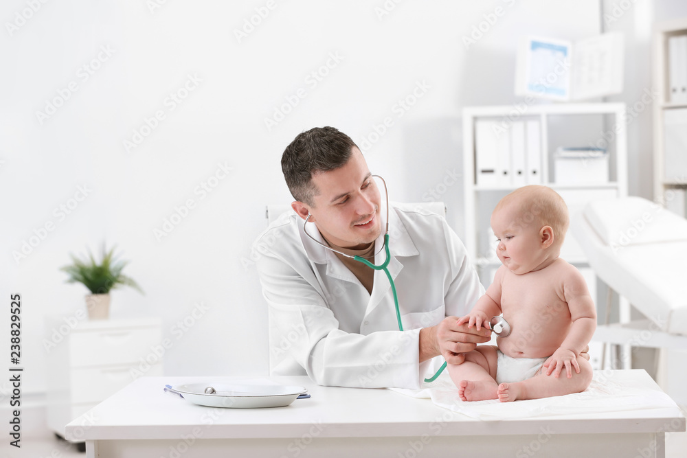 Children's doctor examining baby with stethoscope in hospital Children's doctor examining baby with stethoscope in hospital