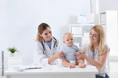 Woman with her baby visiting children s doctor in hospital