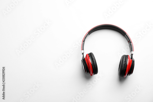 Stylish modern headphones with earmuffs on white background, top view. Space for text