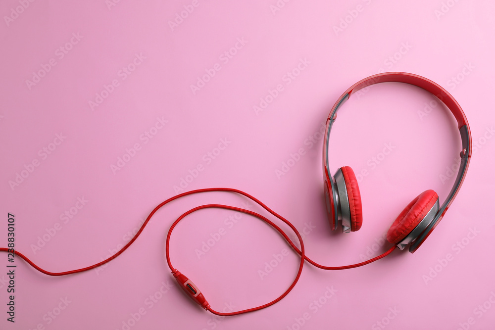 Stylish headphones on color background, top view. Space for text Stylish headphones on color background, top view. Space for text