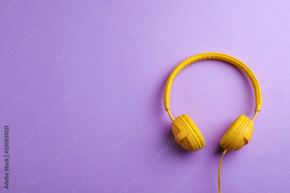 Stylish headphones on color background, top view. Space for text Stylish headphones on color background, top view. Space for text