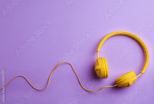 Stylish headphones on color background, top view. Space for text