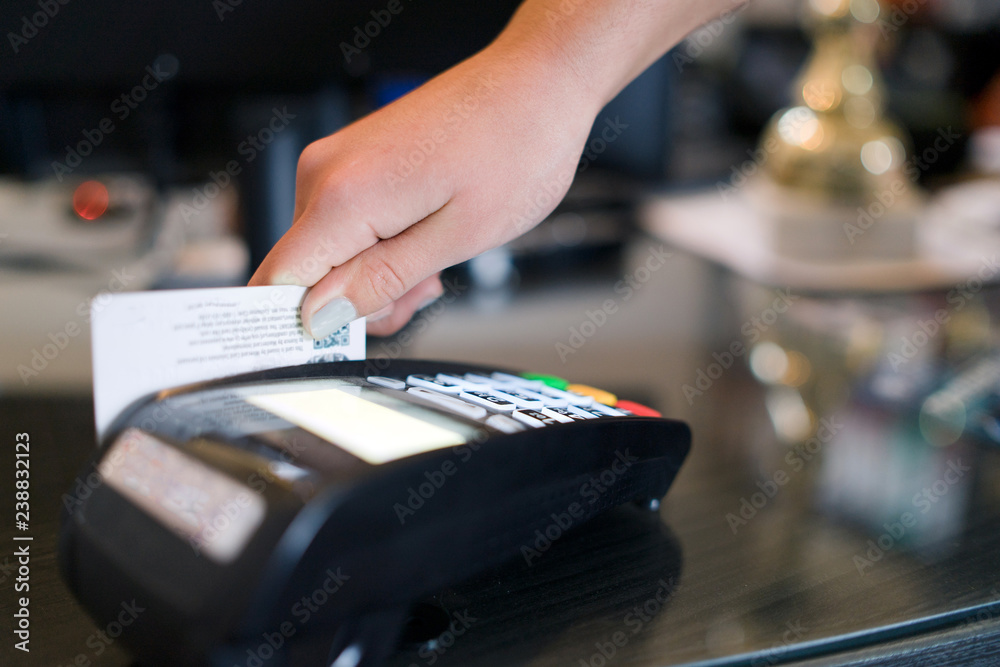Close up on hand Paying with Credit card on the terminal 