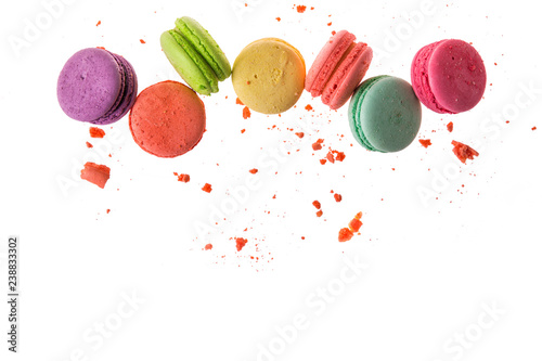Flat lay, top view. French macaroons isolated on white background. Cookies falls mixed with crumbs. Copy space.