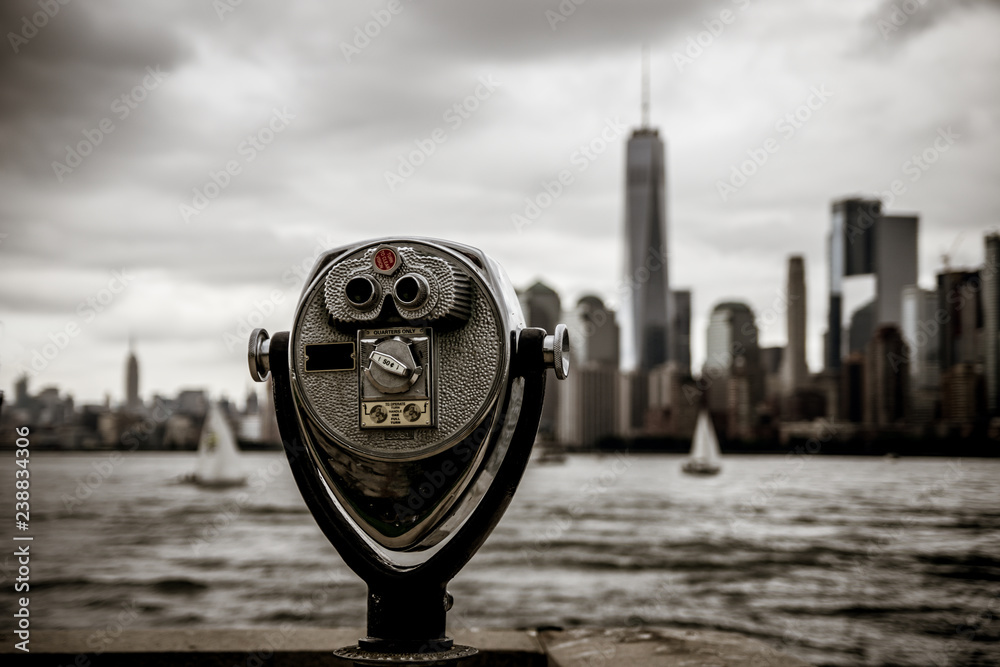 Binoculars in Ellis Island with view to Manhattan skyline new york