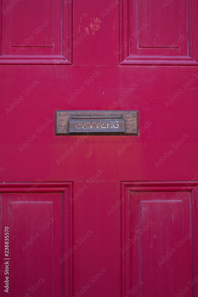 Brass letter slot on a restored red door in center city philadelphia