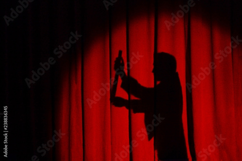 Magician silhouette isolated on the red background