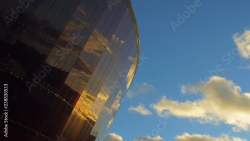 Facade of concert hall Lielais Dzintars (Great Amber) in Liepaja, Latvia with clouds, reflections in windows, medium shot photo