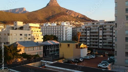 A slow drone ascent revealing the Cape Town Atlantic Seaboard skyline and Lion's Head. photo