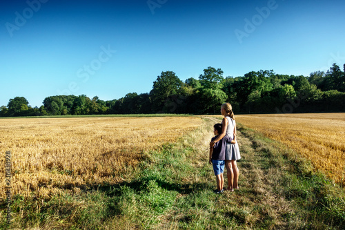 Mother and son standing in field